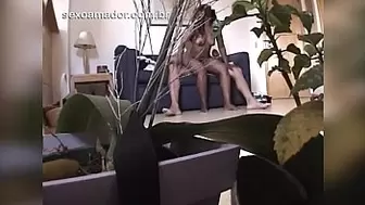 Camouflaged webcam in plant pot films man fucking fresh mulatto whore in living room
