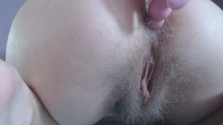 Pink Anal beads in hairy butt-hole close up under white panties
